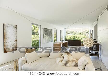 Stock Image - Sofas and desk in modern living space. Fotosearch