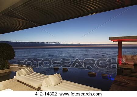 Sofas and infinity pool overlooking ocean View Large Photo Image Stock Image - Sofas and infinity pool overlooking ocean. Fotosearch