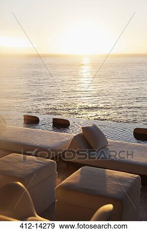 Sofas and infinity pool overlooking ocean View Large Photo Image Stock Photo - Sofas and infinity pool overlooking ocean. Fotosearch