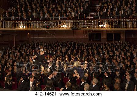 Stock Image - Spotlight on angry audience members in theater. Fotosearch