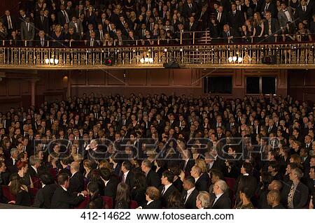 Spotlight on audience member using cell phone in theater View Large Photo Image Stock Image - Spotlight on audience member using cell phone in theater. Fotosearch