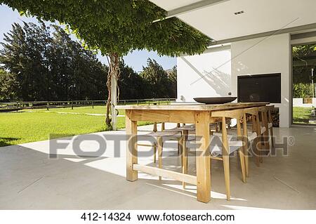 Picture - Table and chairs on luxury patio. Fotosearch