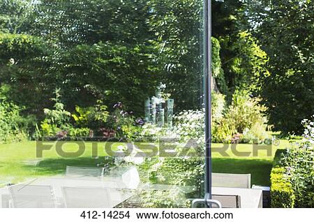 View of landscaped garden through open door View Large Photo Image Picture - View of landscaped garden through open door. Fotosearch