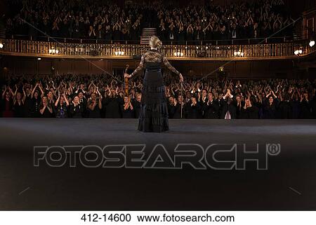 Stock Image - Violinist performing on stage in theater. Fotosearch