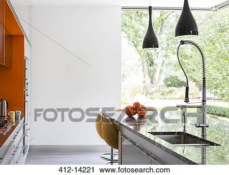 Stock Image - Wall art and counters in modern kitchen. Fotosearch