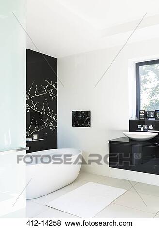 Stock Photo - Wall art and soaking tub in modern bathroom. Fotosearch
