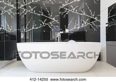 Wall art and soaking tub in modern bathroom View Large Photo Image Stock Photography - Wall art and soaking tub in modern bathroom. Fotosearch