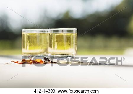 Stock Photo - White wine on table outdoors. Fotosearch