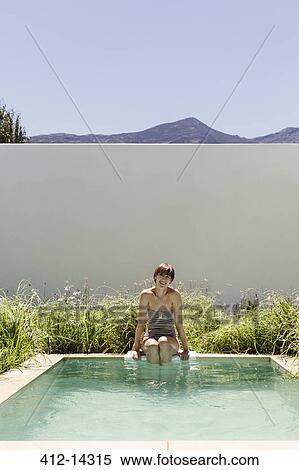 Woman dipping legs in luxury lap pool View Large Photo Image Stock Photography - Woman dipping legs in luxury lap pool. Fotosearch