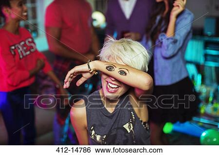 Woman holding tattoo of eyes over her face View Large Photo Image Stock Photograph - Woman holding tattoo of eyes over her face. Fotosearch