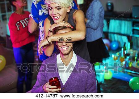 Woman holding tattoo of eyes over boyfriend's face View Large Photo Image Stock Photo - Woman holding tattoo of eyes over boyfriend's face. Fotosearch