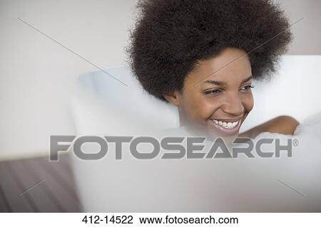 Stock Image - Woman laughing in bath. Fotosearch