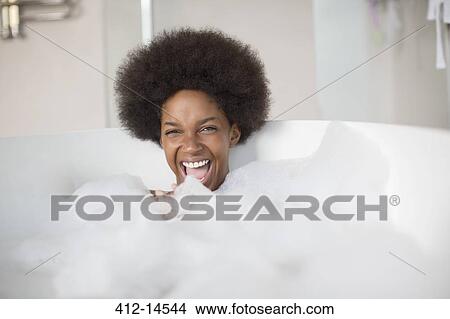 Woman laughing in bubble bath View Large Photo Image Picture - Woman laughing in bubble bath. Fotosearch