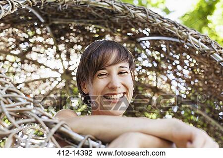 Woman laughing in tree house View Large Photo Image Stock Image - Woman laughing in tree house. Fotosearch