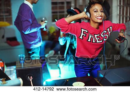 Woman playing music and dancing at party View Large Photo Image Stock Image - Woman playing music and dancing at party. Fotosearch