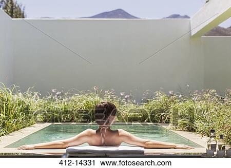 Woman relaxing in luxury lap pool View Large Photo Image Stock Image - Woman relaxing in luxury lap pool. Fotosearch
