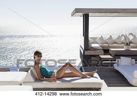 Woman relaxing on sofa outdoors View Large Photo Image Stock Photo - Woman relaxing on sofa outdoors. Fotosearch