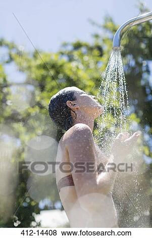 Stock Photo - Woman showering outdoors. Fotosearch