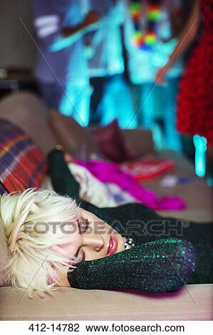 Woman sleeping on sofa at party View Large Photo Image Stock Image - Woman sleeping on sofa at party. Fotosearch