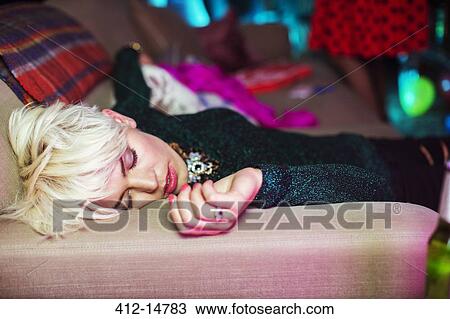 Woman sleeping on sofa at party View Large Photo Image Stock Image - Woman sleeping on sofa at party. Fotosearch