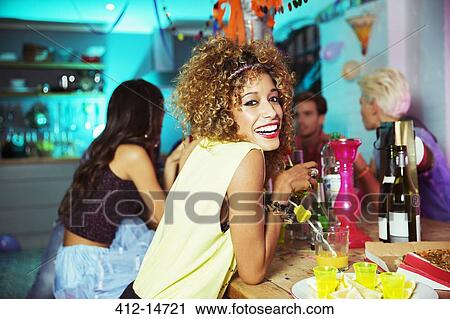 Stock Image - Woman smiling at party. Fotosearch