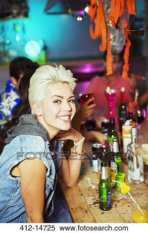 Stock Photography - Woman smiling at party. Fotosearch