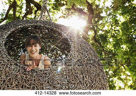 Woman smiling in nest tree house View Large Photo Image Stock Photo - Woman smiling in nest tree house. Fotosearch