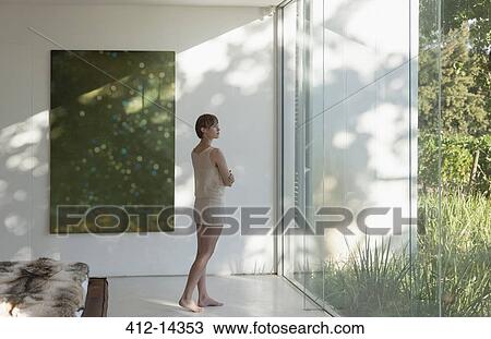 Woman standing at window in modern bedroom View Large Photo Image Stock Image - Woman standing at window in modern bedroom. Fotosearch