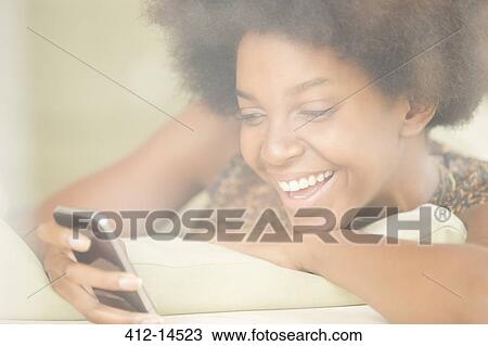 Woman using cell phone View Large Photo Image Stock Image - Woman using cell phone. Fotosearch