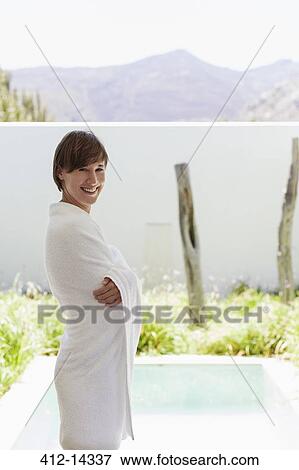 Stock Photo - Woman wrapped in towel at poolside. Fotosearch