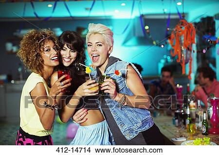 Picture - Women enjoying cocktails at party. Fotosearch