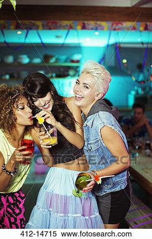 Stock Photography - Women enjoying cocktails at party. Fotosearch