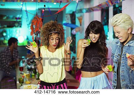 Women taking shots at party View Large Photo Image Stock Photograph - Women taking shots at party. Fotosearch
