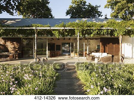 Wooden walkway through garden to modern house View Large Photo Image Stock Photograph - Wooden walkway through garden to modern house. Fotosearch