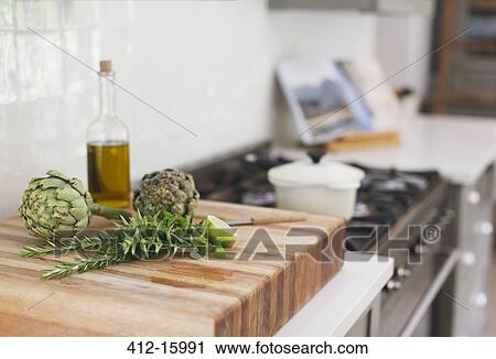 Artichokes, rosemary, olive oil and lime on cutting board View Large Photo Image Stock Image - Artichokes, rosemary, olive oil and lime on cutting board. Fotosearch