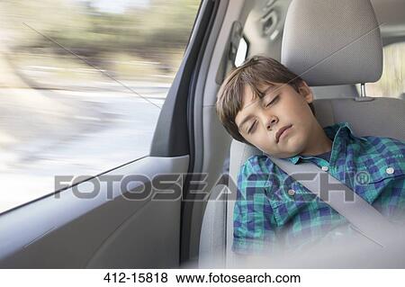 Boy sleeping in back seat of car View Large Photo Image Stock Photo - Boy sleeping in back seat of car. Fotosearch