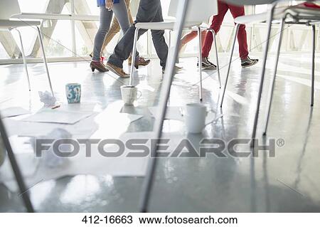 Business people walking away from coffee cups and paperwork at circle of chairs View Large Photo Image Stock Image - Business people walking away from coffee cups and paperwork at circle of chairs. Fotosearch