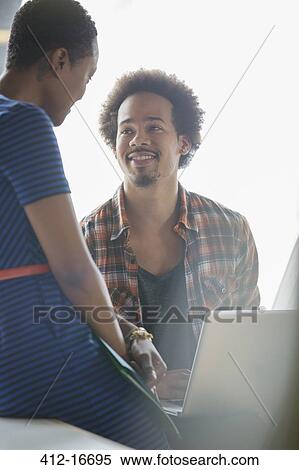 Businessman and businesswoman using laptop in meeting View Large Photo Image Stock Photography - Businessman and businesswoman using laptop in meeting . Fotosearch