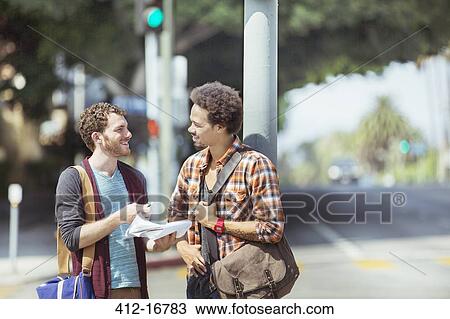 Businessmen with paperwork on urban street View Large Photo Image Stock Image - Businessmen with paperwork on urban street. Fotosearch