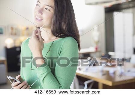 Businesswoman using hands-free device with cell phone View Large Photo Image Stock Photo - Businesswoman using hands-free device with cell phone. Fotosearch