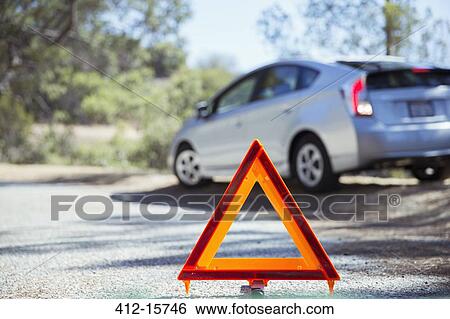 Car at roadside behind warning triangle View Large Photo Image Stock Photograph - Car at roadside behind warning triangle. Fotosearch