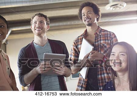 Casual business people smiling in meeting View Large Photo Image Stock Image - Casual business people smiling in meeting. Fotosearch