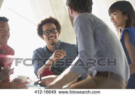 Casual business people talking in meeting View Large Photo Image Stock Photo - Casual business people talking in meeting. Fotosearch