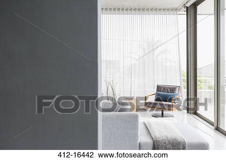 Chair in corner of modern living room View Large Photo Image Stock Image - Chair in corner of modern living room. Fotosearch