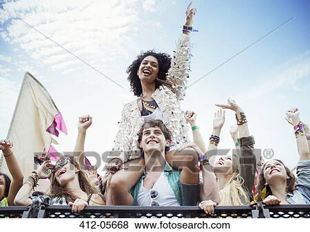 Cheering woman on man's shoulders at music festival View Large Photo Image Stock Photo - Cheering woman on man's shoulders at music festival. Fotosearch