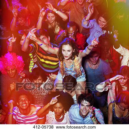 Stock Photo - Cheering woman on man's shoulders at music festival. Fotosearch