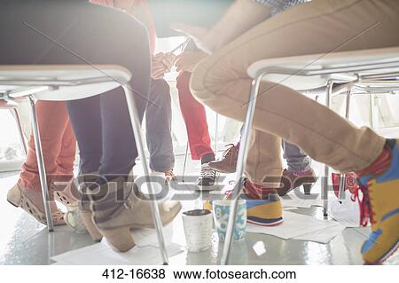 Close up of creative business people meeting in circle of chairs View Large Photo Image Stock Photo - Close up of creative business people meeting in circle of chairs. Fotosearch