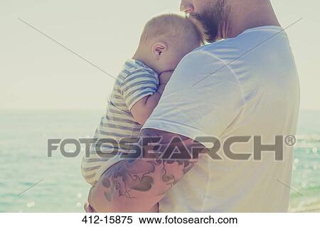 Close up of father holding baby son at beach View Large Photo Image Stock Photography - Close up of father holding baby son at beach. Fotosearch