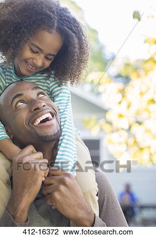 Close up of happy father carrying daughter on shoulders View Large Photo Image Stock Image - Close up of happy father carrying daughter on shoulders. Fotosearch