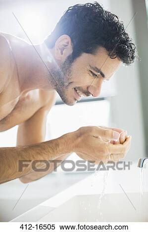 Close up of man washing face at sink View Large Photo Image Stock Photography - Close up of man washing face at sink. Fotosearch
